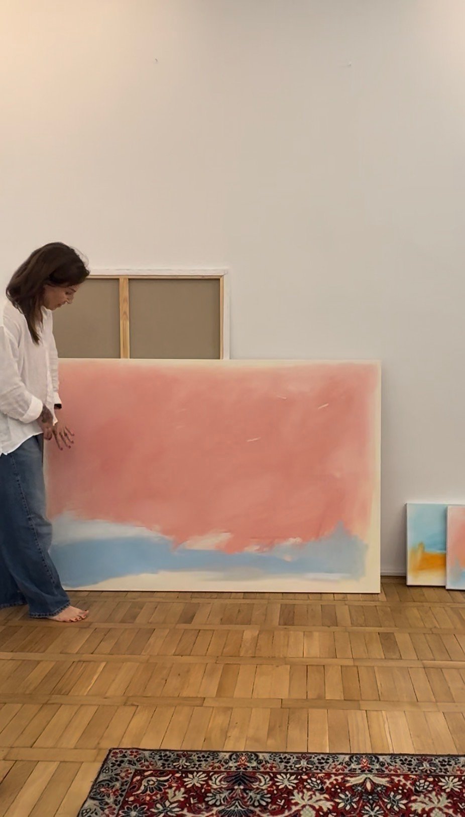 Ada Kamińska standing beside an abstract painting in her Gdańsk studio